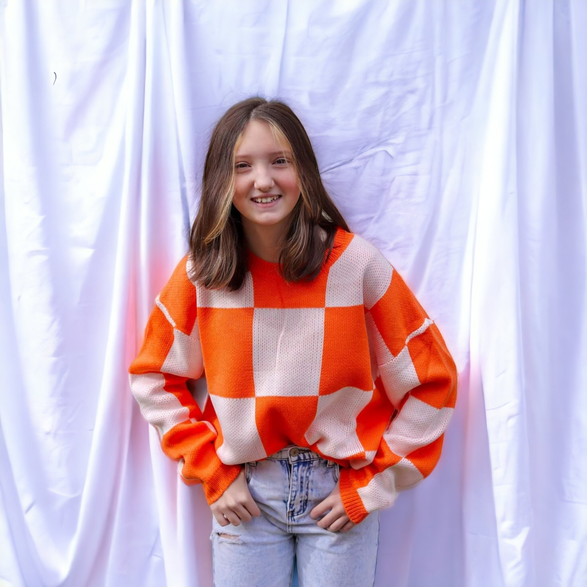 White and 2025 orange sweater